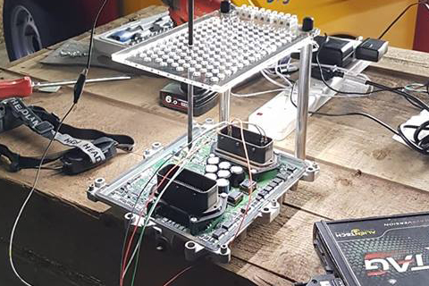 ECU being remapped on a wooden desk